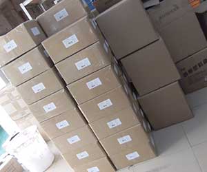 A stack of small, labeled cardboard boxes containing car cleaning clay.