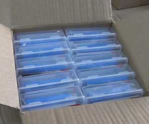 An open large shipping box showing multiple individually packaged car wash clay bars inside.