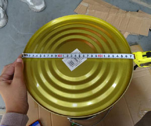 Fashion bucket base size test: Quality control size measurement of the fashion bucket seat base using a tape measure.
