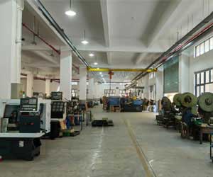Wide view of a clean, well-lit factory floor or production line, showing various large machines used for manufacturing the tools.