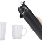 Set of black insulated bottles, a clear glass tumbler, and a mug with a handle, showing a complete travel hydration and glassware set